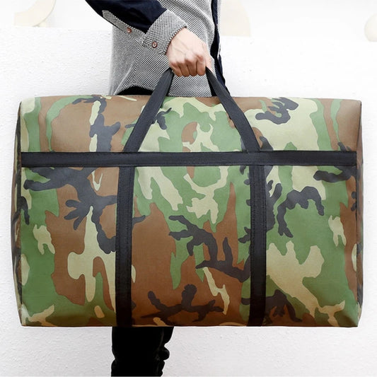 Person holding a large camouflage duffel bag against a white background