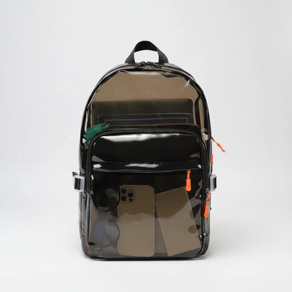 A clear vinyl backpack with black trim, black zippers, and black straps, shown against a plain white background. The front pocket is open, revealing various items inside.