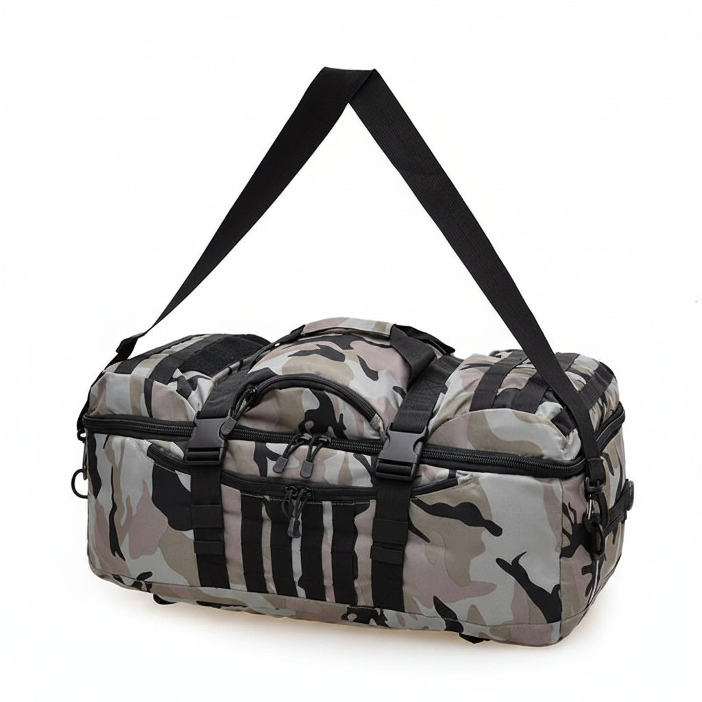 A duffel bag with a gray, black, and beige camouflage pattern, featuring black straps, buckles, and a long shoulder strap, shown on a plain white background.