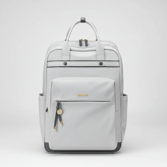 A light gray backpack with dual top handles, a front zippered pocket, side pockets, and small gold-tone hardware details, shown against a plain white background.
