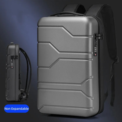 A metallic gray hard-shell laptop backpack shown from the front and side, with a small blue label reading 'Non Expandable' in the lower left corner.