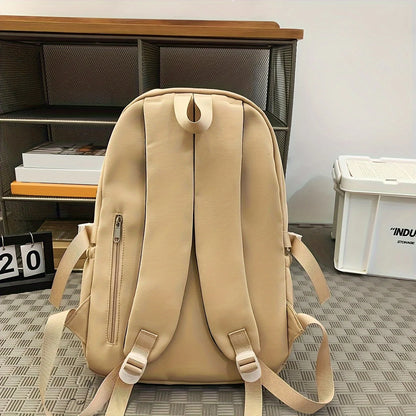 Beige backpack on a checkered floor with a bookshelf and white container in the background