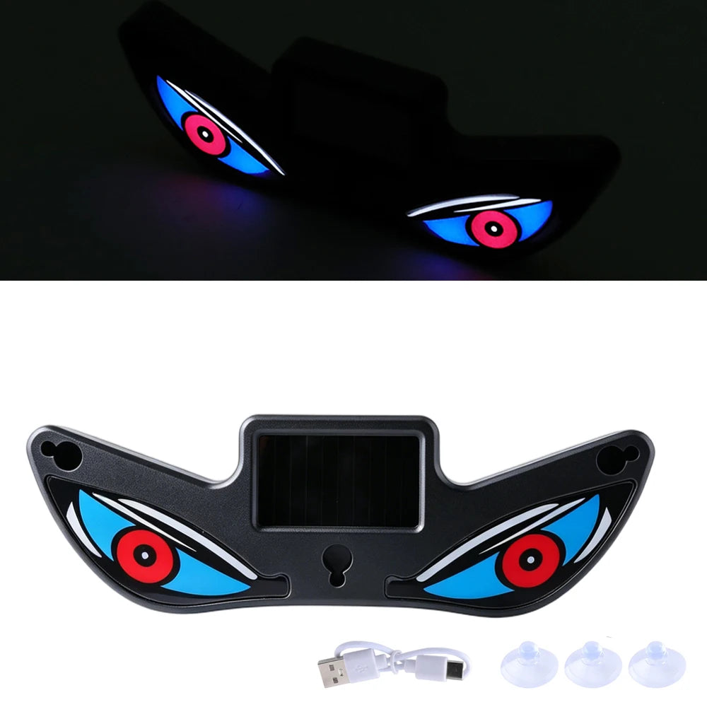 Black LED eye-shaped car light with USB cable on a white background