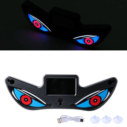 Black LED eye-shaped car light with USB cable on a white background