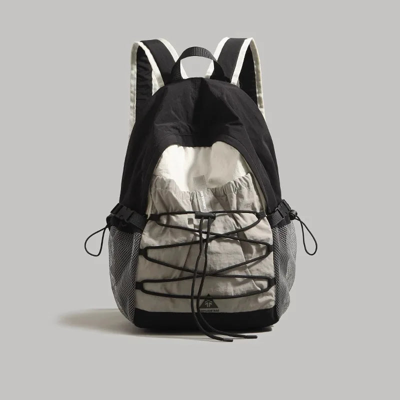Black and gray camouflage backpack on a light gray background