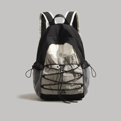 Black and gray camouflage backpack on a light gray background