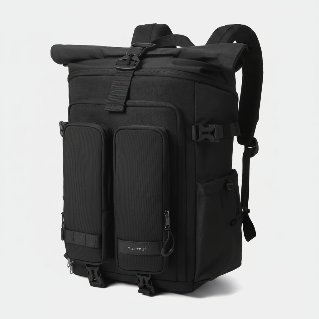 Black backpack with multiple pockets and straps on a light gray background
