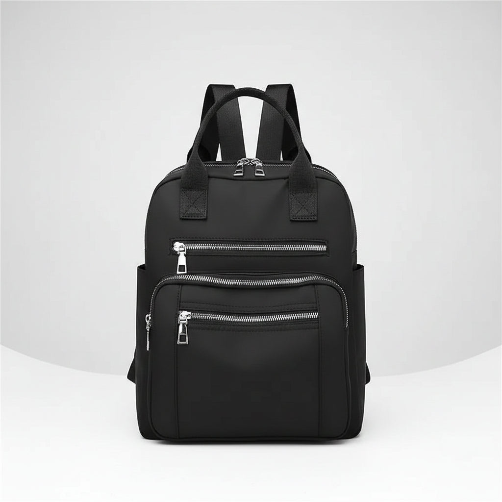 Black backpack with multiple zippers on a white background