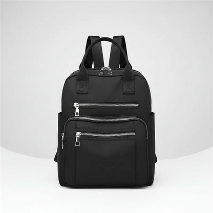 Black backpack with multiple zippers on a white background
