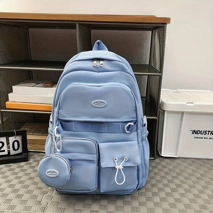Blue backpack with a brand logo on a patterned floor next to a bookshelf.
