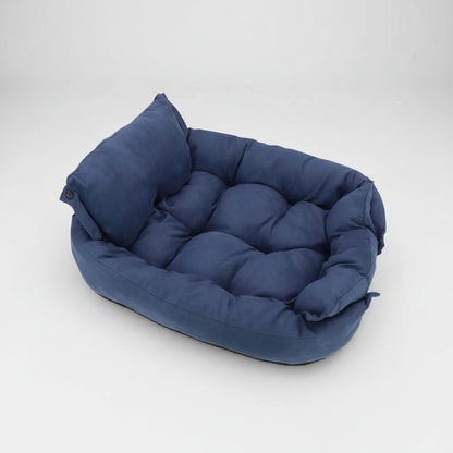 Blue pet bed with a pillow on a white background