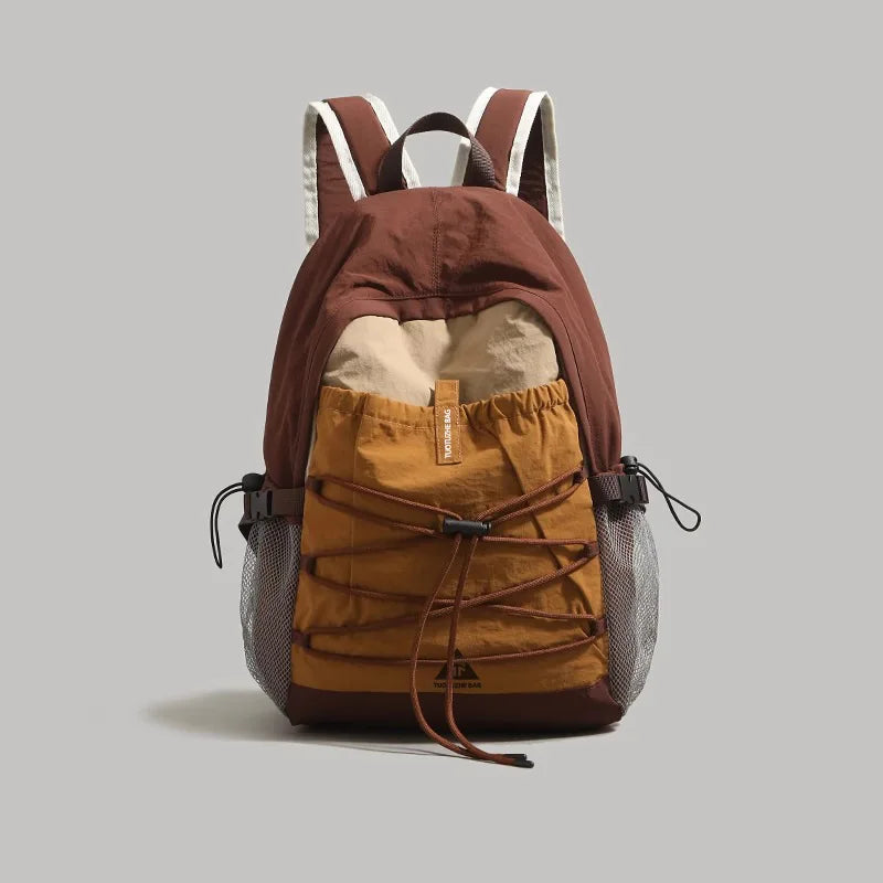 Brown and beige backpack on a gray background