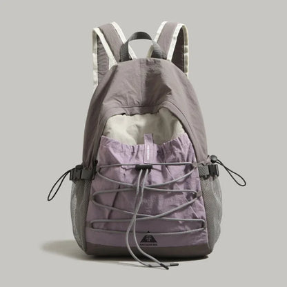 Gray and purple backpack on a light gray background