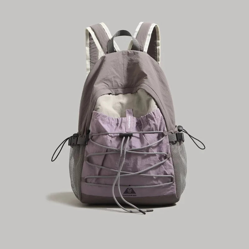 Gray and purple backpack on a light gray background
