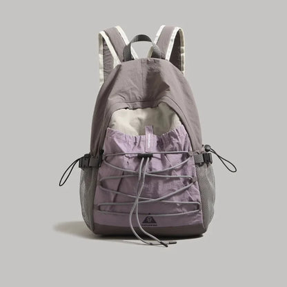 Gray and purple backpack on a light gray background