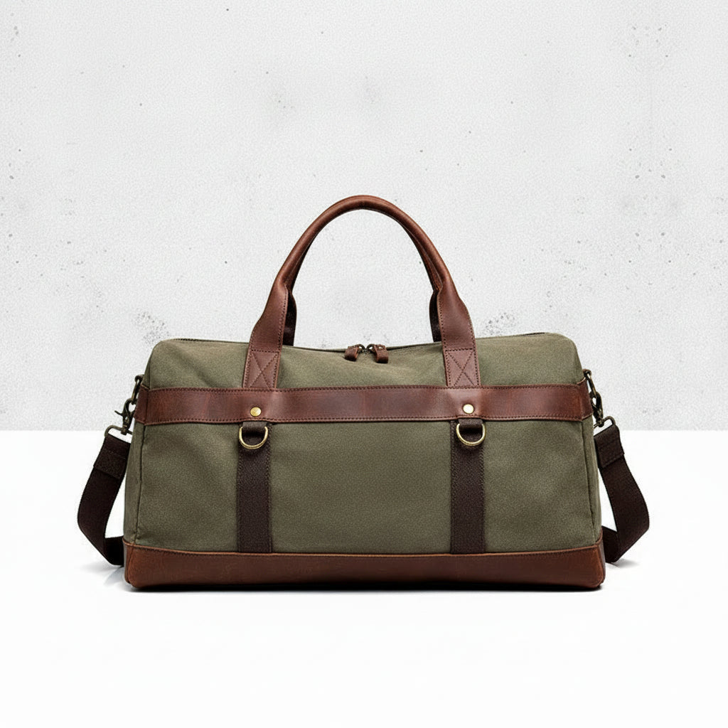Green duffel bag with brown leather straps on a light gray background