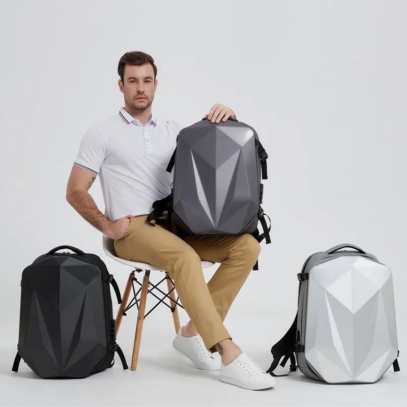 Man sitting on a chair with a geometric-patterned backpack, surrounded by three backpacks on a light gray background.
