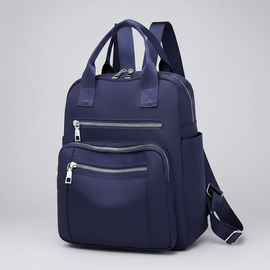Navy blue backpack with multiple zippers on a white background