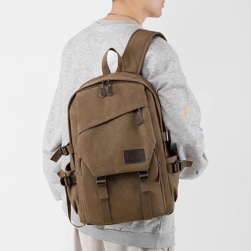 Person wearing a brown backpack on a light gray background