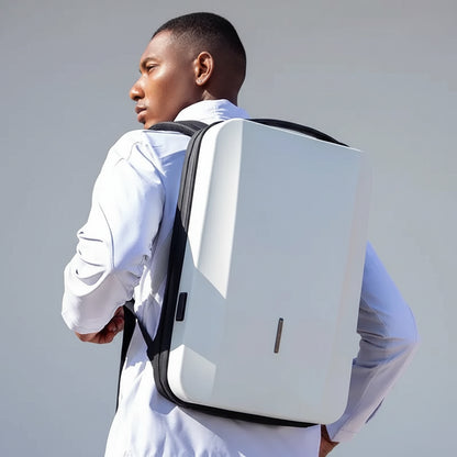 Person wearing a large white backpack against a red rock background