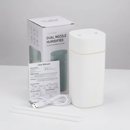 White dual nozzle humidifier with packaging and USB cable on a white background